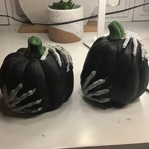 Black pumpkins with skeleton hands